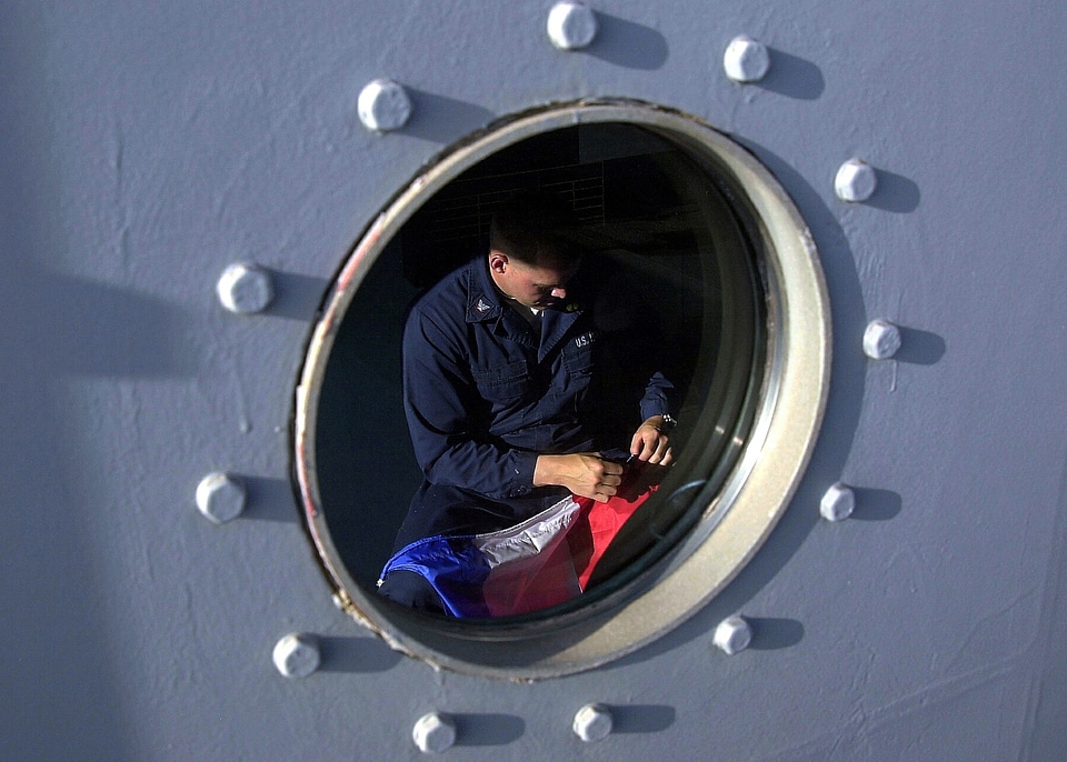 Mending a flag us navy at sea