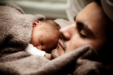 Sleep baby with dad, closeup faces photo