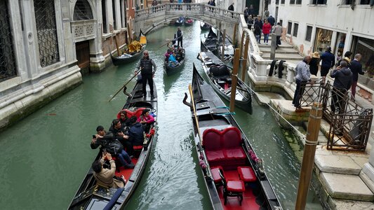 Traditional gondolas on narrow canal in Venice, Italy photo
