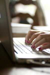 Female Hands Typing On A Laptop Keyboard photo