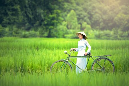 Beautiful Vietnamese woman, Walked with the bike photo