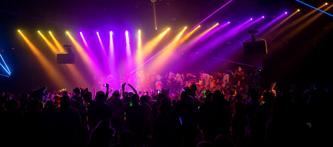 dj night club party rave with crowd in music festival photo