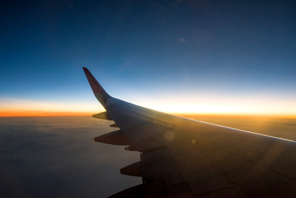 Sunset sky on airplane, plane window