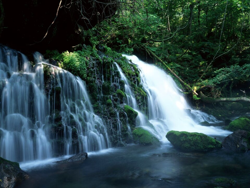 Waterfall rushing down the rocks, blue toning