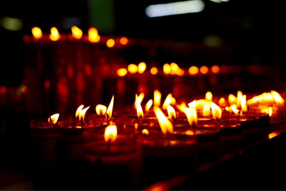 Group of burning candles on black background