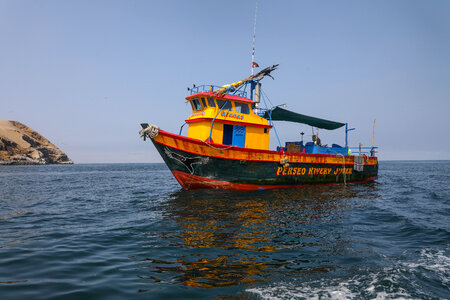 Fishing boat floating on the water, blue sea and sky