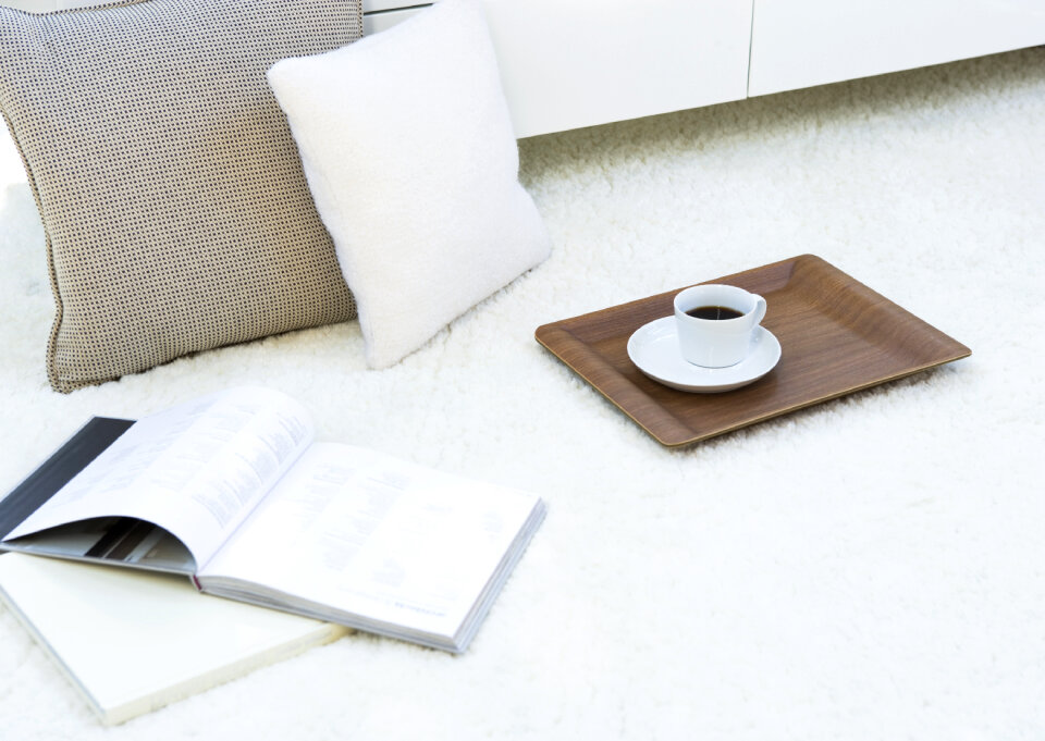 Composition with warm plaid, book, cup of hot drink