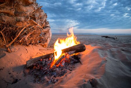Beach campfire on lake with sand shore