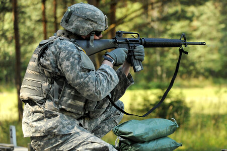 U.S. Army soldier fires his weapon photo