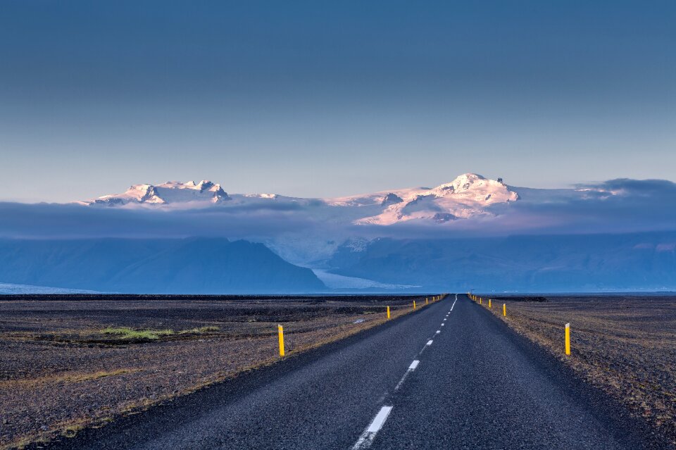 Empty road leading to snow covered mountains Iceland