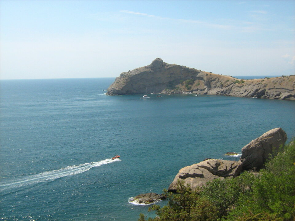 Rocky cape in sea at evening. Crimea, Novy Svet, Kapchik.