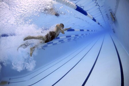 Male swimmer at the swimming pool.Underwater photo. photo