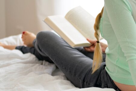 woman on the bed with book photo