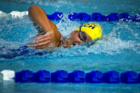 Young female swimming the front crawl in a pool photo