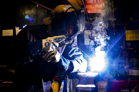 U.S. Navy Fireman welds a pipe
