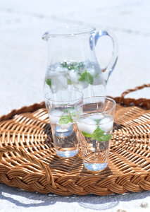 Glass of water and fresh herbs photo