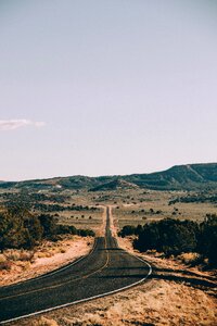 A long, straight highway cuts through the Arizona desert