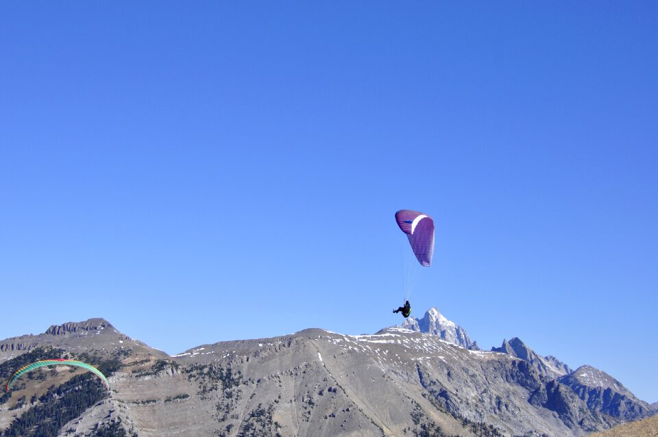 Paraglider taking off from a mountain
