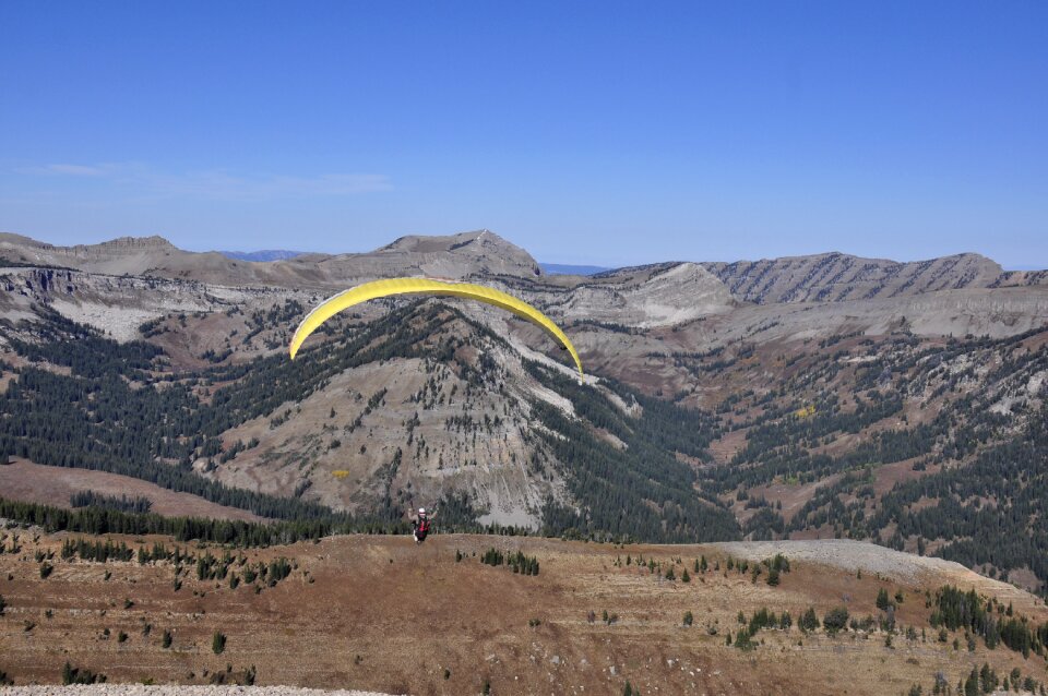 Paraglider taking off from a mountain