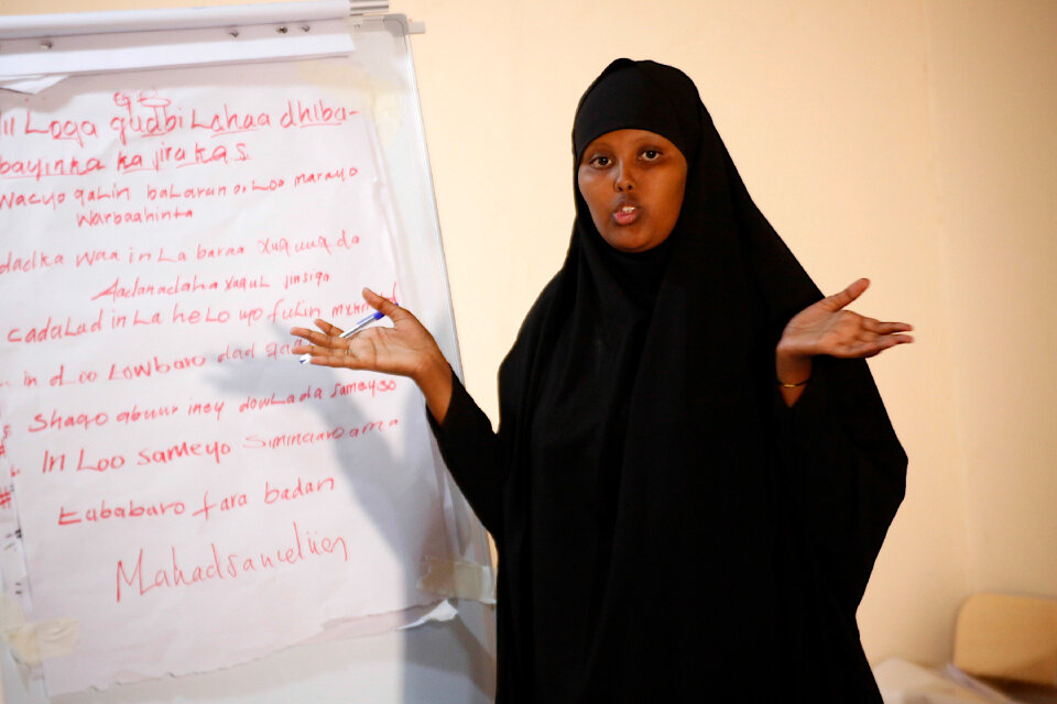 A female participant makes a presentation during a workshop