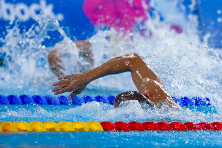 male professional participants racing in pool