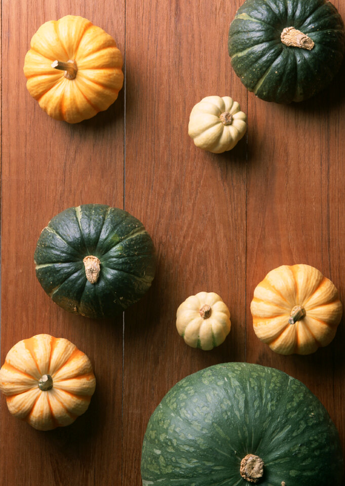Autumn pumpkins on wooden board
