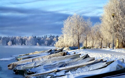 Boats covered with snow in Finland photo