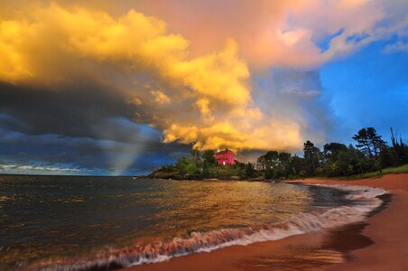 Marquette Lighthouse at sunset with thunderstorm clouds