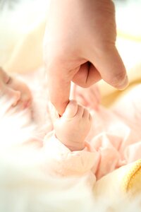 concept of love and family. hands of mother and baby closeup photo