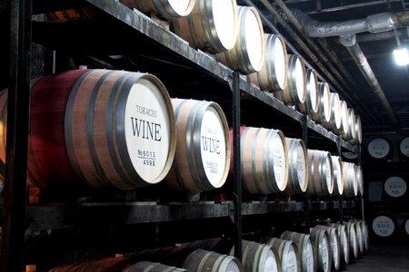 Wine barrels stacked in the old cellar of the winery photo