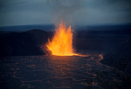 Lava fountain shimmers across lava lake in Kīlauea Iki Crater photo