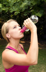 A Young Woman Drinking Water During Exercise photo