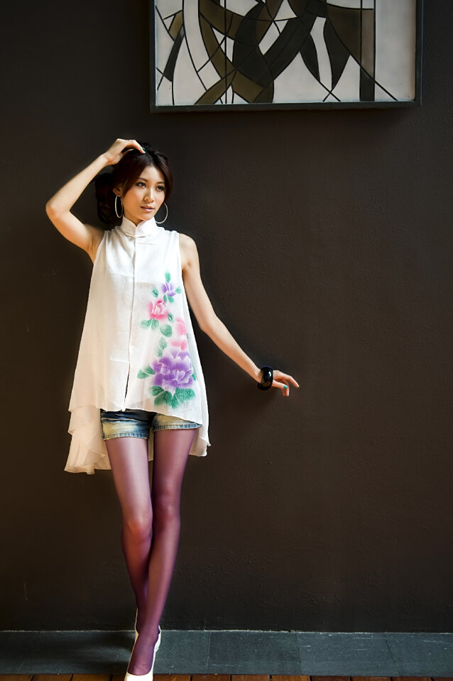 A Beautiful Woman Posing Against A Wall