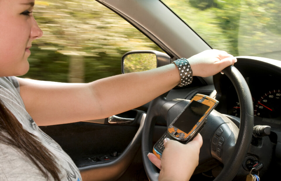 A Teen Girl Texting While Driving