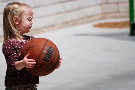 Cute girl holding basketball