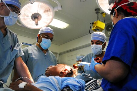 Team of surgeon in uniform perform operation on a patient photo