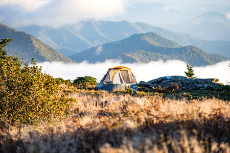 Camping Tent on Peach Leveled With Clouds Near Mountain photo