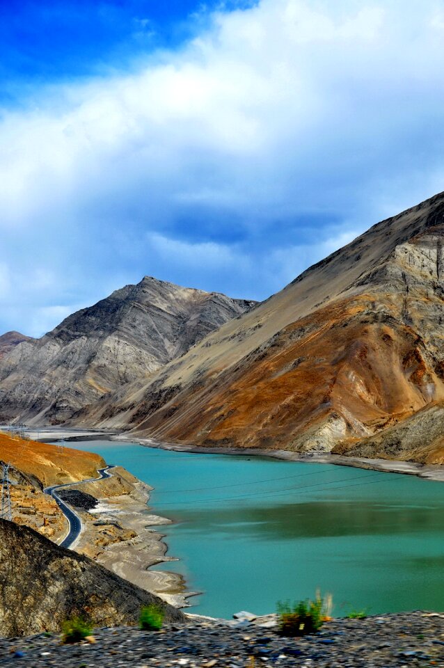 Yamdrok-tso lake shines on sunny blue sky day in Tibet