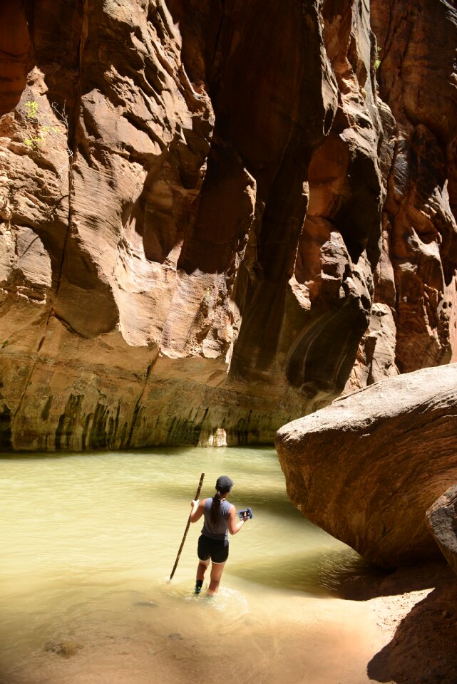 Group Of Tourists Hiking In The Cold River