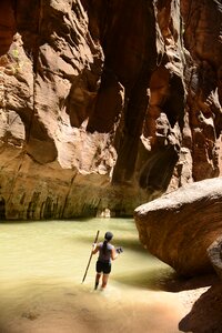 Group Of Tourists Hiking In The Cold River