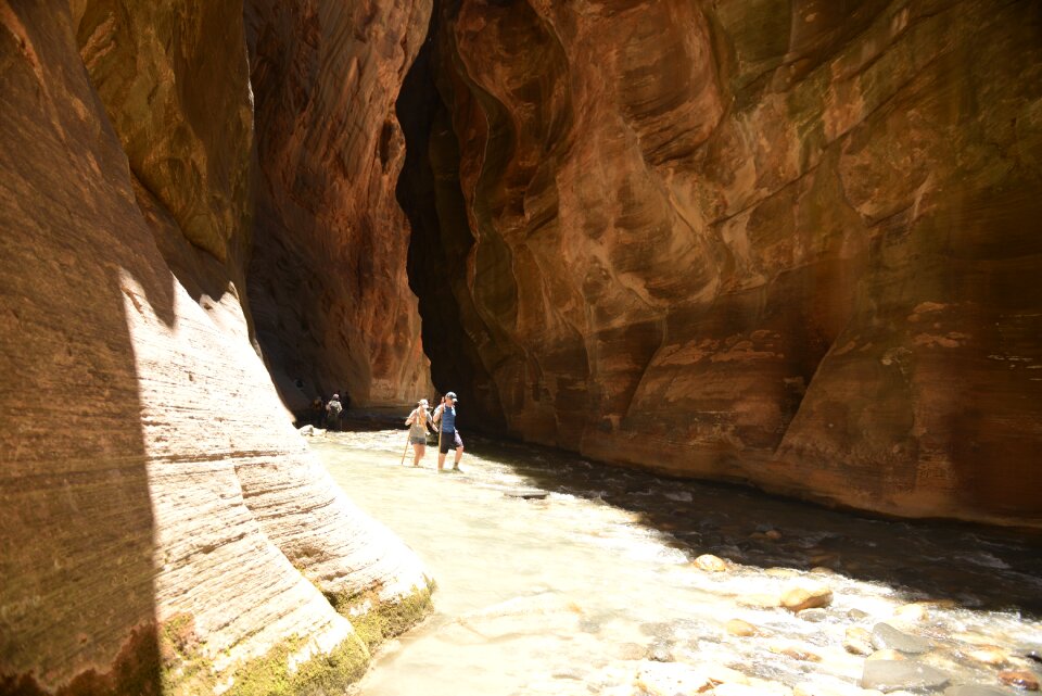 Group Of Tourists Hiking In The Cold River