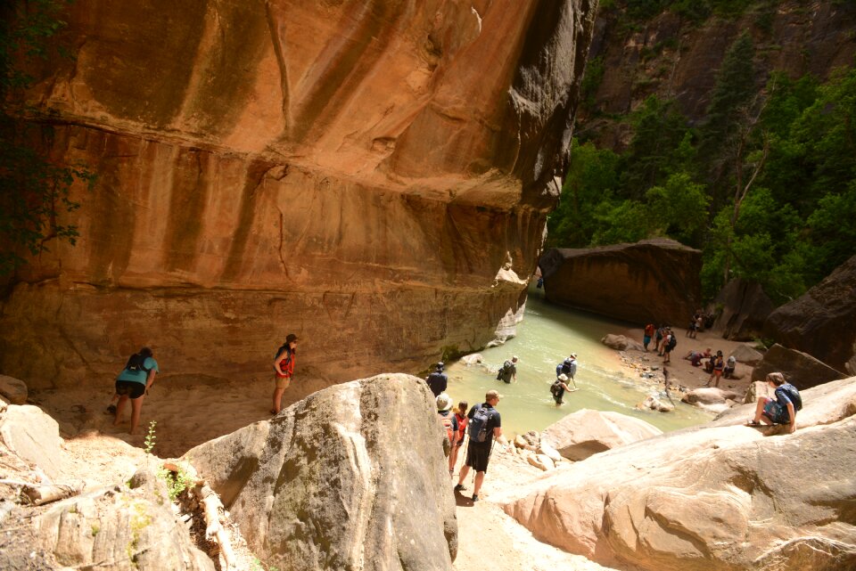 Group Of Tourists Hiking In The Cold River