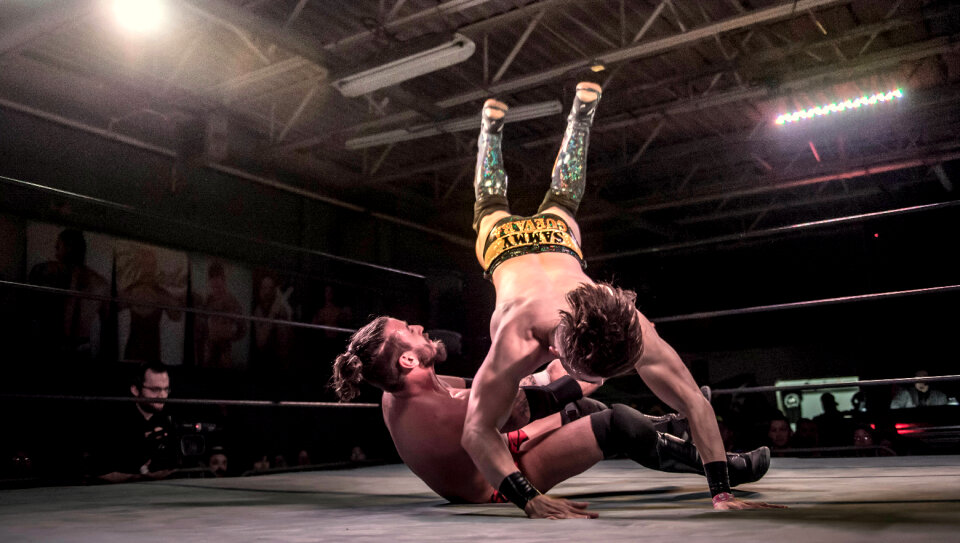 Two Men Battle for Control in Wrestling Match