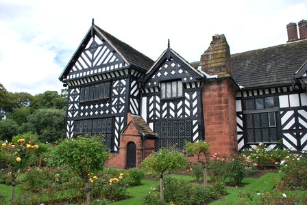 Black and white timber framed medieval mansion house and gardens. photo