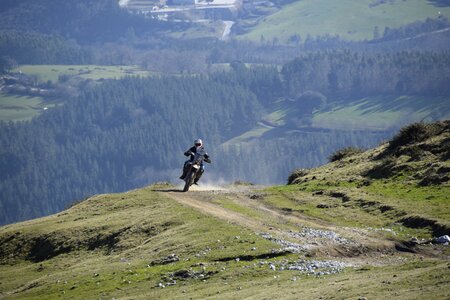 man riding sport touring motorcycle on dirt field photo