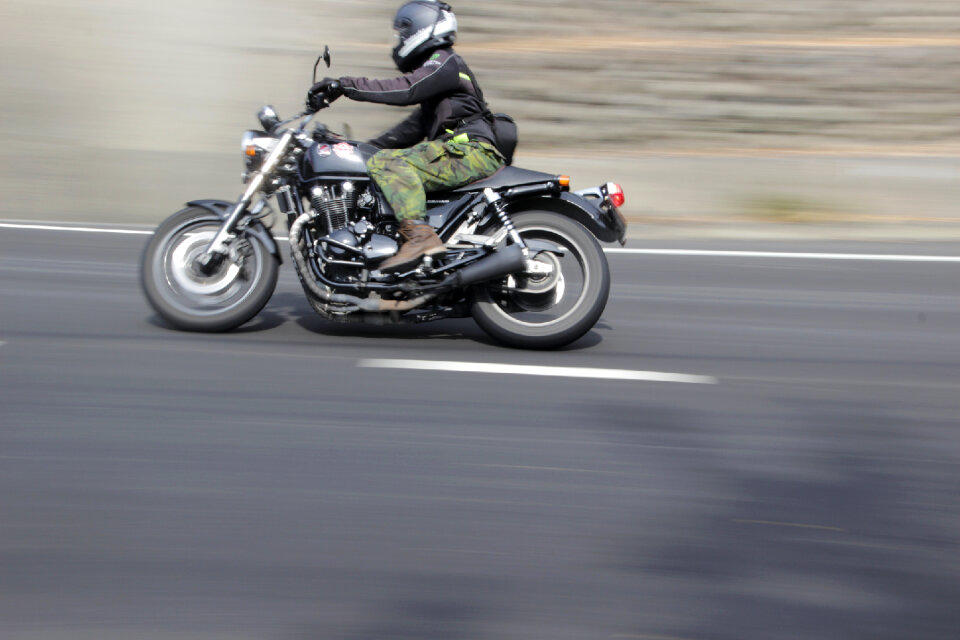 man riding sport touring motorcycle on dirt field