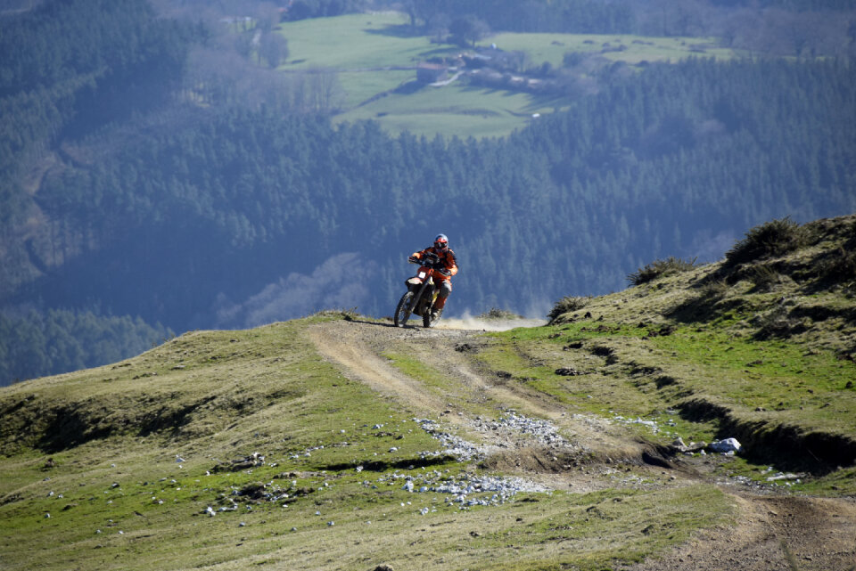 man riding sport touring motorcycle on dirt field