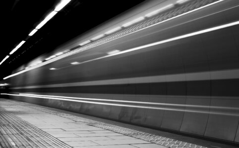 Fast moving train on underground platform photo