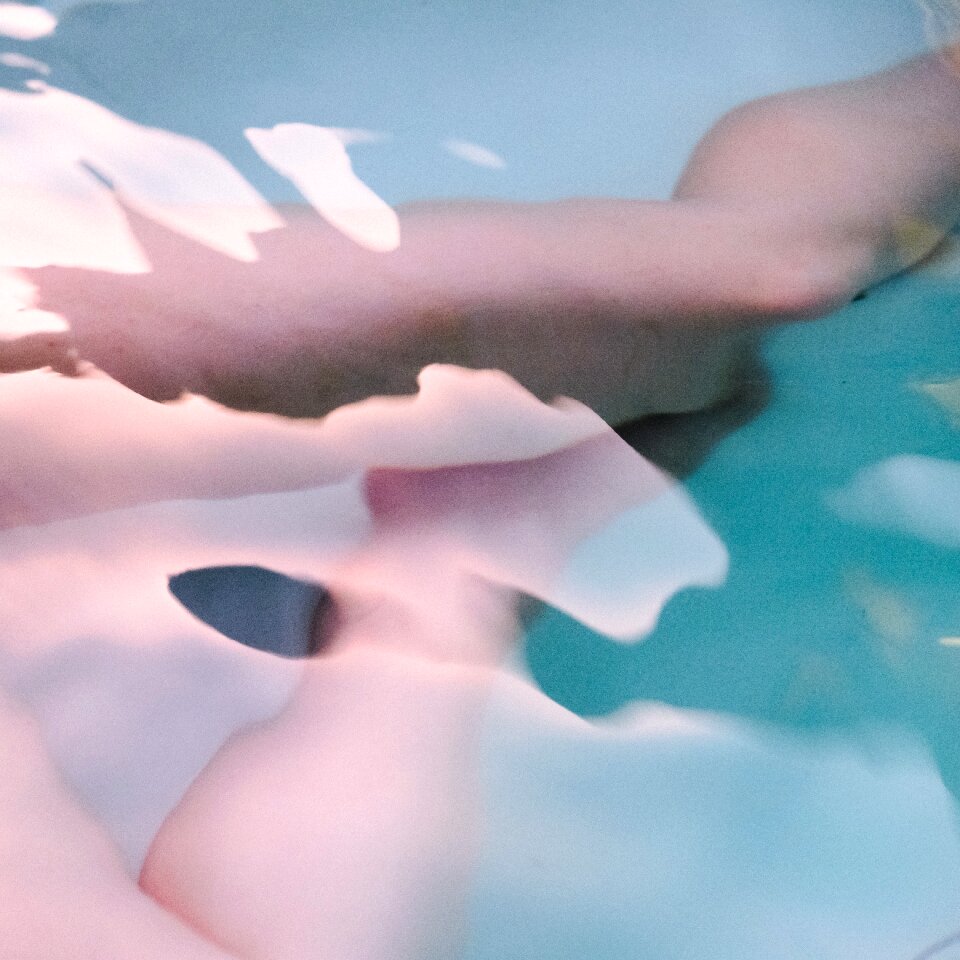 Beautiful woman legs in swimming pool