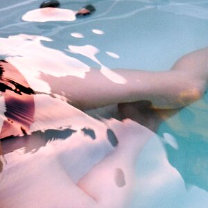 Beautiful woman legs in swimming pool photo